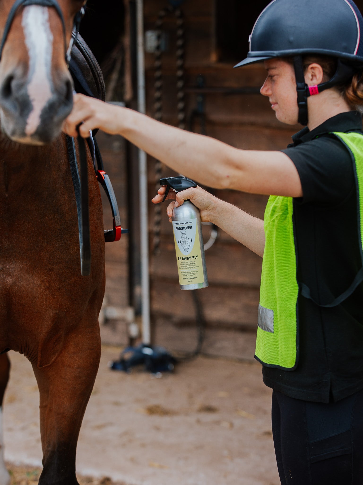 Person applying our Go Away Fly spray to a horse before going for a hack